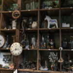 Bangkok, Thailand - Jun 26, 2020 : Wall clocks and Collectibles on handmade wooden rustic wall shelf in Living room Vintage style. Selective focus.